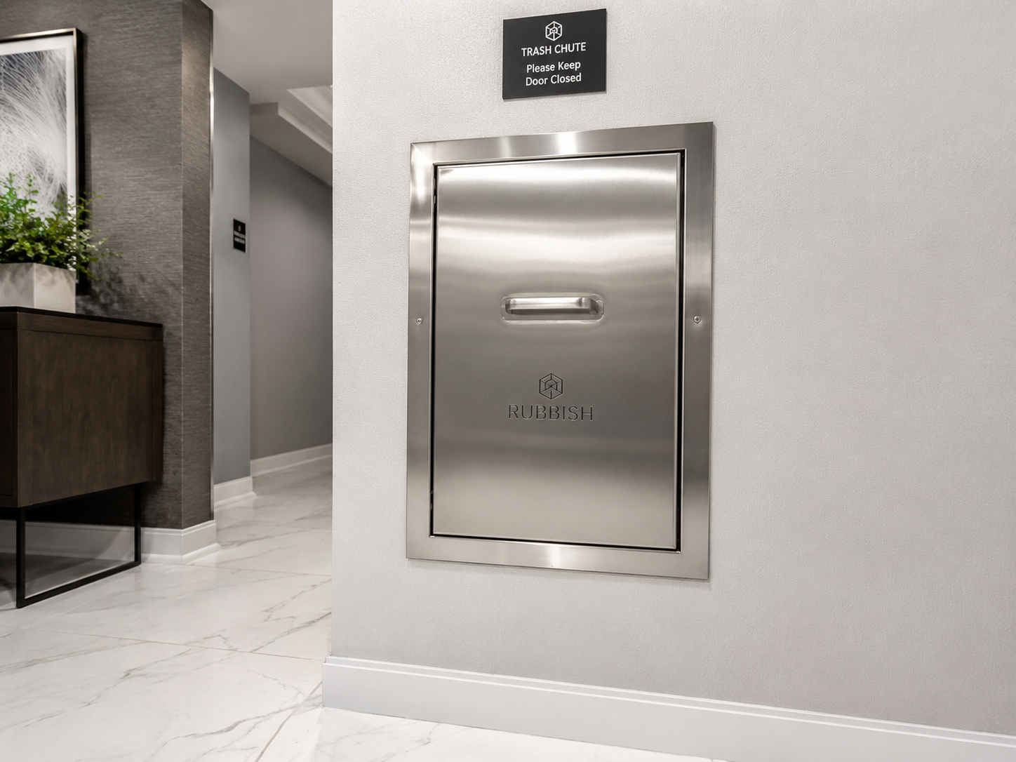 Clean stainless steel trash chute door in a bright corridor with a clear wall sign